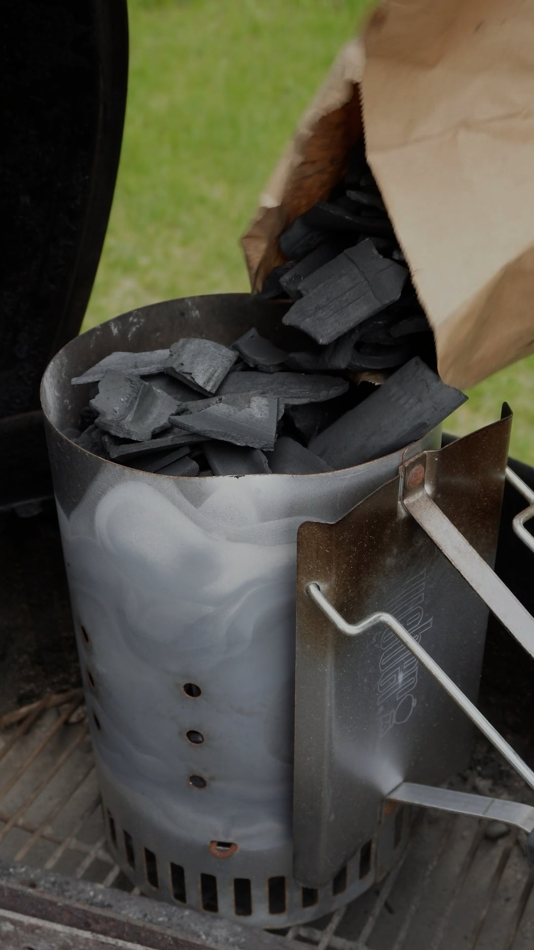 BAM bamboo charcoal being poured into a chimney starter